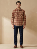 Model wearing The Plaid Corduroy Shirt in Red Plaid. Generated image; the manufacturer's own photograph of this garment appears below.